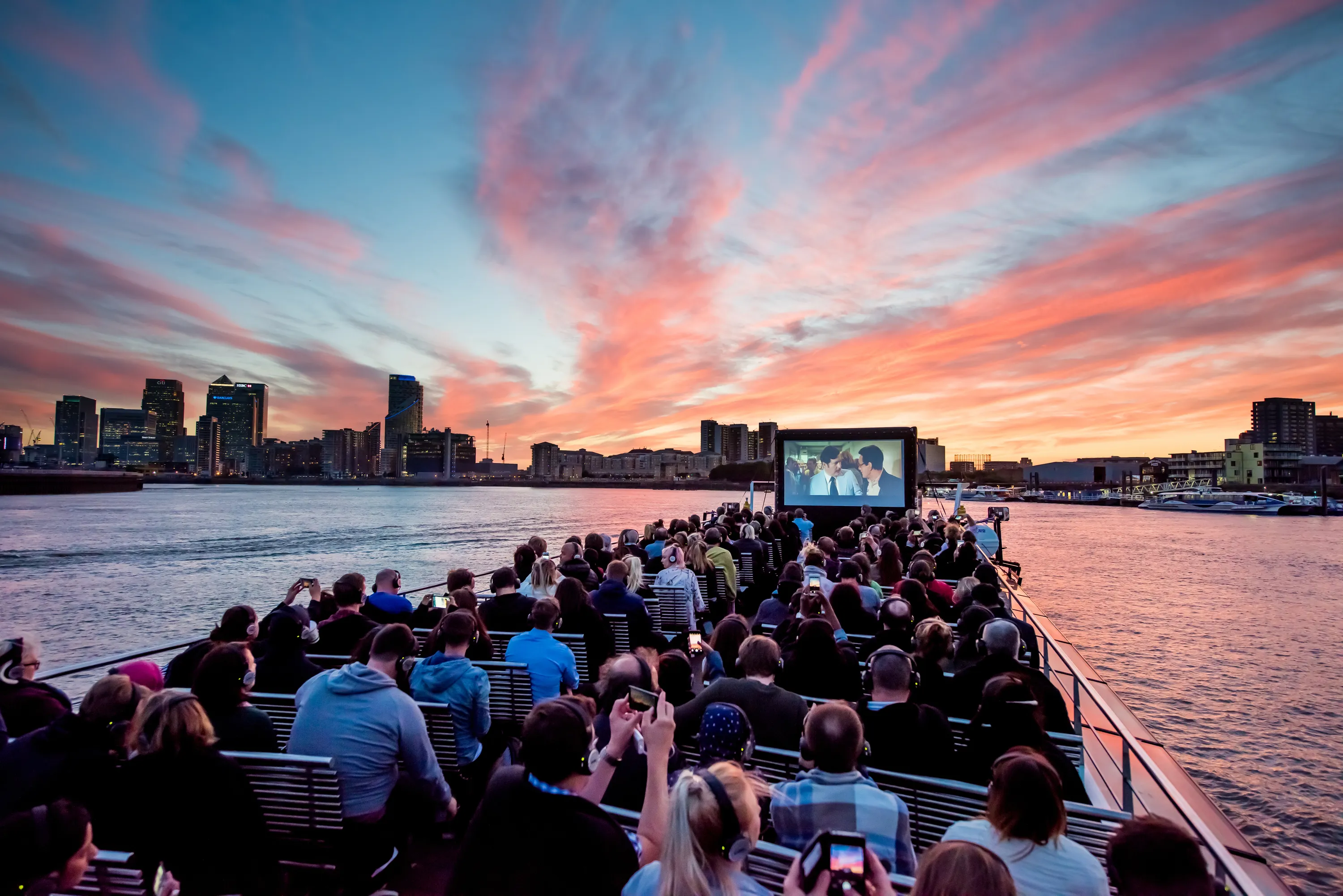 people on a boat with cinema screen