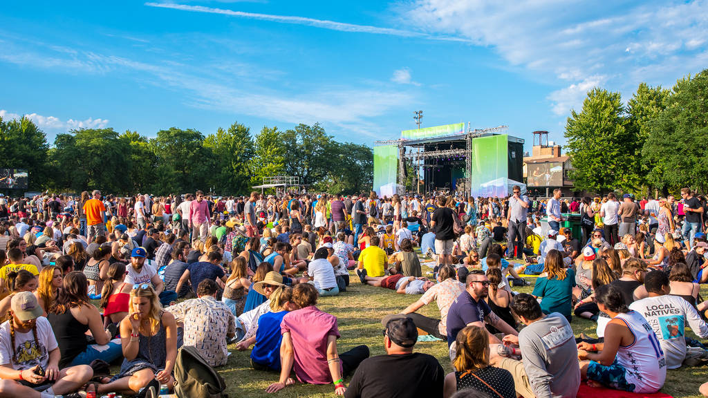 People sit on the lawn chatting among themselves at Pitchfork.