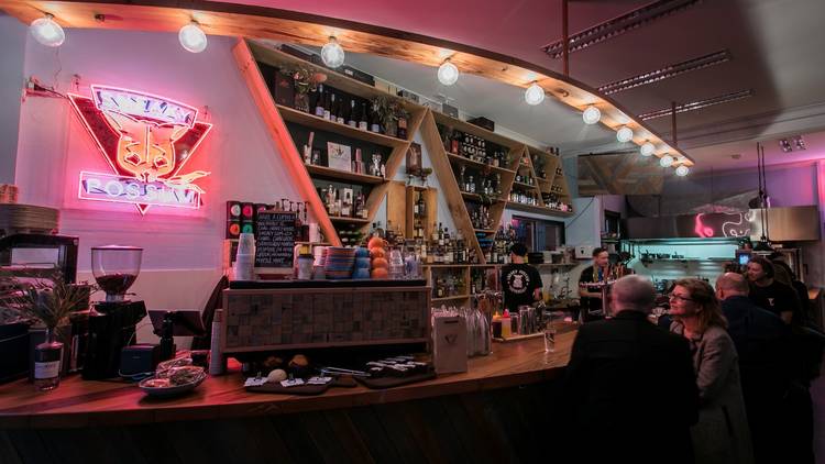 Pink neon lights inside the Sneaky Possum bar