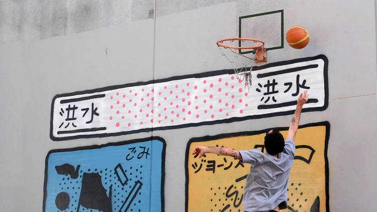 Man shooting basketball through a hoop