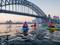 Three people kayaking toward harbour bridge for Sydney by Kayak