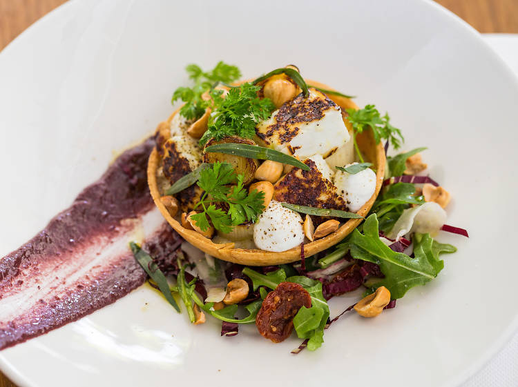 Roasted leek and fennel tart, buffalo haloumi, biter leaves, tapenade, hazelnuts and tarragon at Harvey's Bar and Bistro, $18