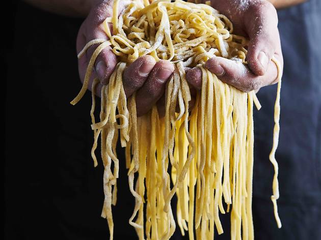 Fresh pasta at Vizio Caffe e Cucina Hands holding fresh pasta