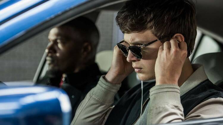 Baby (Ansel Elgort) and Bats (Jamie Foxx) on the way to the post office job with Buddy (Jon Hamm) and Darling (Eiza Gonzalez) as cops pull up next to them in TriStar Pictures' Baby Driver, directed by Edgar Wright.&#13;Photo: Wilson Webb.&#13;Copyright: 2