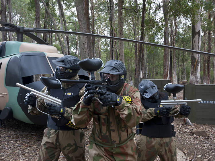 Paintball players in action