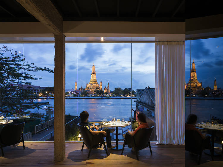 Diners overlooking the water from a Bangkok Restaurant