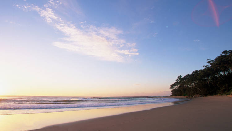 View of the sun reflecting off the ocean at South Curl Curl Beac