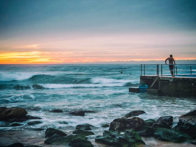 Man Standing by the Ocean pool at South Curl Curl NSW Man Standing by the Ocean pool at South Curl Curl NSW