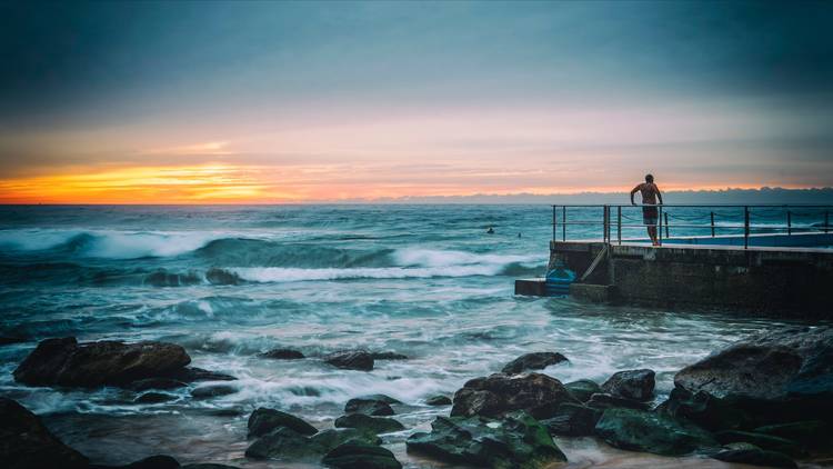 Man Standing by the Ocean pool at South Curl Curl NSW