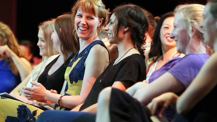 Women laughing together in the audience