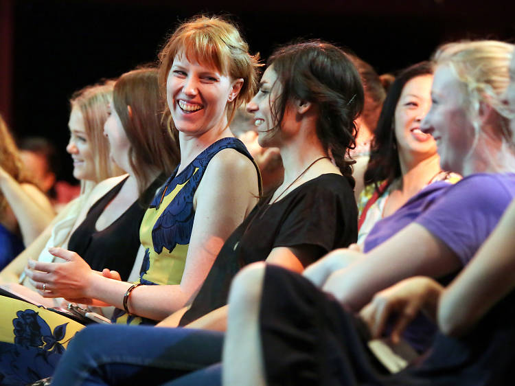 Women laughing together in the audience