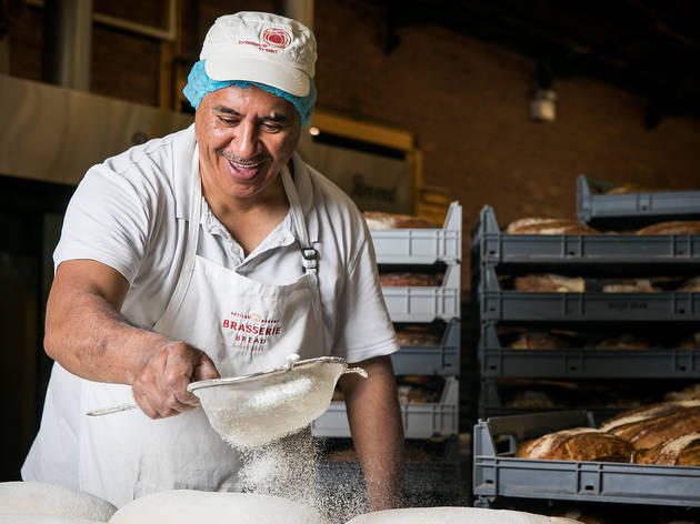 Richard the Baker pouring flour over dough at Brasserie Bread Richard the Baker pouring flour over dough at Brasserie Bread