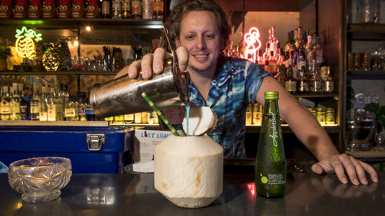 Bartender making an Appletiser cocktail at Lost Luau