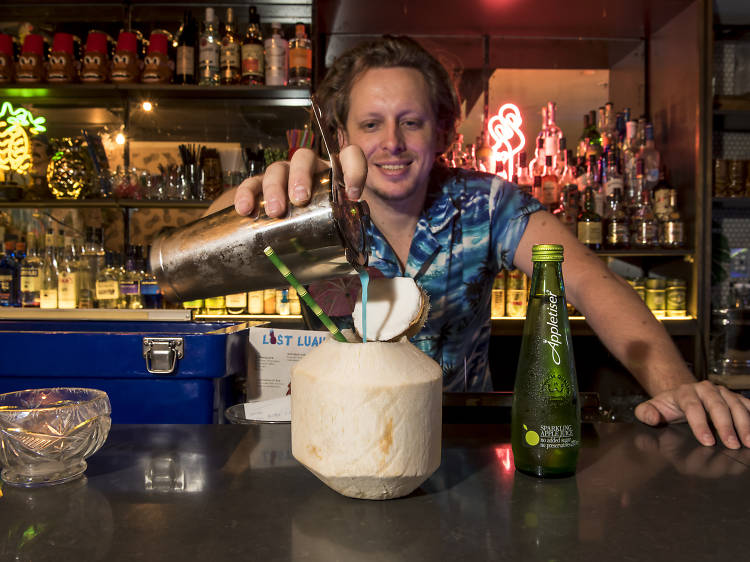 Bartender making an Appletiser cocktail at Lost Luau