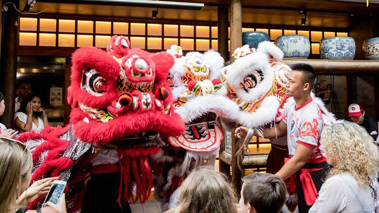 People watch street performers as part of Chinese New Year celebrations