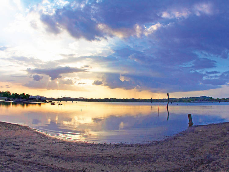 The tranquil Kanchikudichchiaru reservoir against the backdrop of serene nature