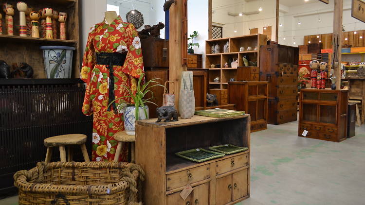 A collection of Japanese and Chinese fabrics and furniture on display in at Tombo