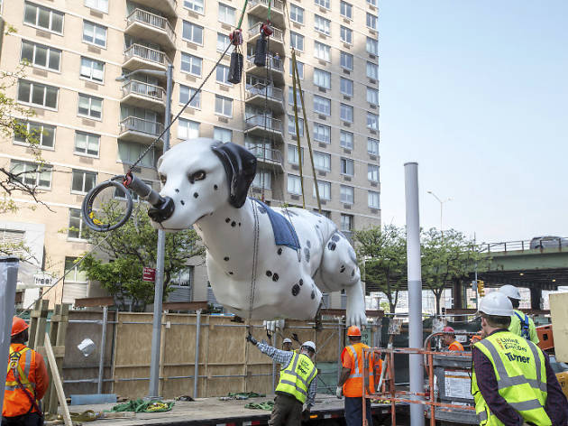 A 38-foot statue of a dog balancing a taxi on its nose was unveiled in midtown A 38-foot statue of a dog balancing a taxi on its nose was unveiled in midtown