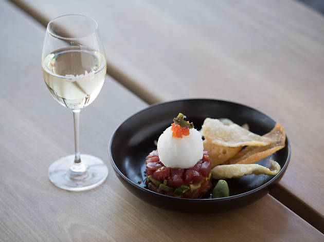 Zushi Barangaroo A plate of sashimi tacos and a glass of wine.