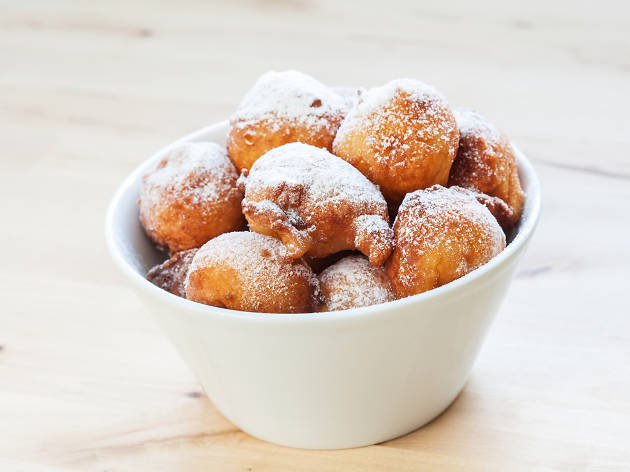 Homemade fritters in white bowl Traditional croatian cookies called Fritule