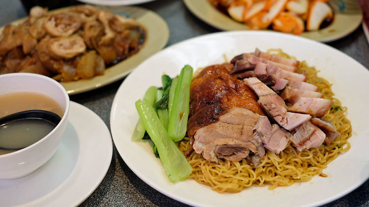 A plate of roast meats on noodles