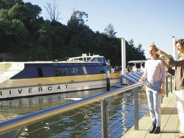Parramatta River ferry Woman pointing at the ferry on the river.