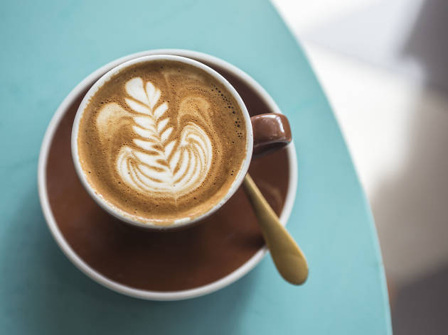 Wild Cockatoo Bakery Cup of coffee on a blue table