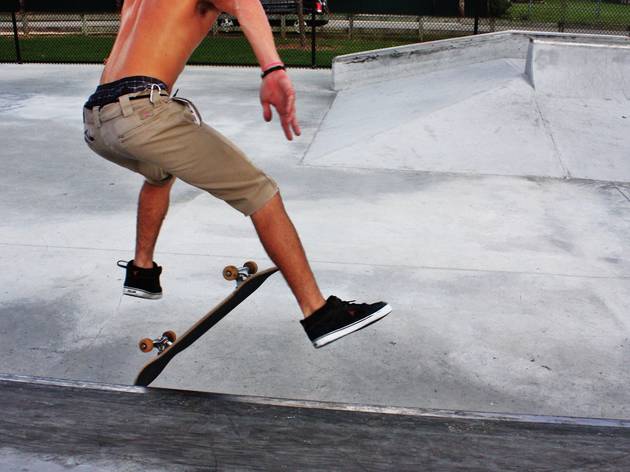 People doing tricks at Skatepark People doing tricks at Skatepark