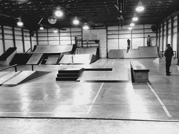People doing tricks at Skatepark People doing tricks at Skatepark