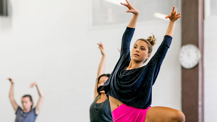 Woman gracefully dances at Sydney Dance Company Studios