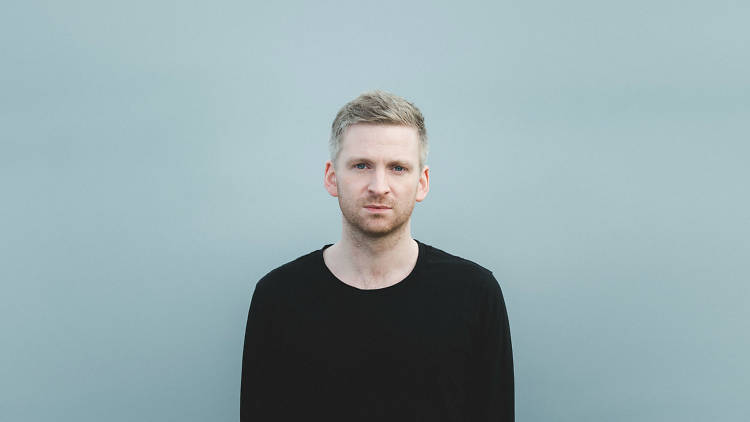 Olafur Arnalds press image in front of blue background