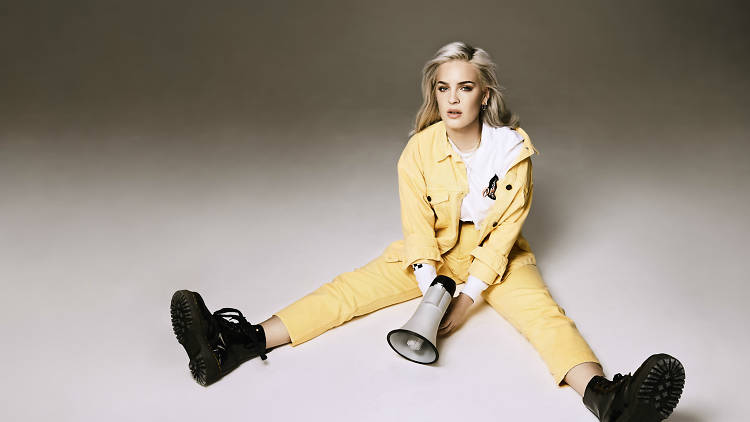 Press photo: Anne-Marie sits in grey background