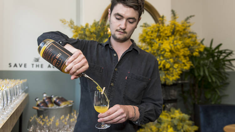 Man pouring cocktail in wattle room
