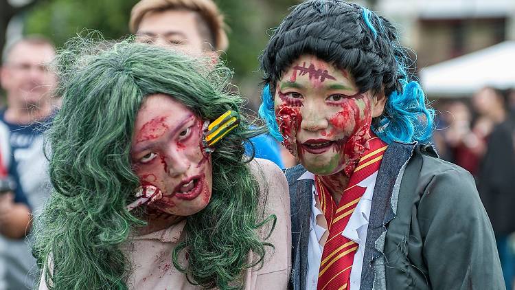 Two girls dressed up as zombies.