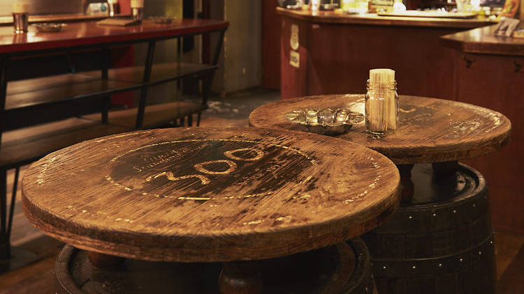 Two circular wooden tables with '300' stamped into them. 