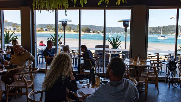 People eating outside Of box on the water central coast