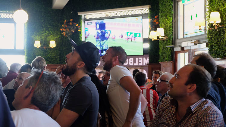 Men watching Melbourne cup Race