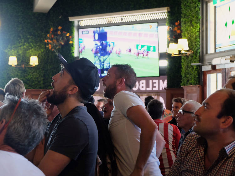 Men watching Melbourne cup Race