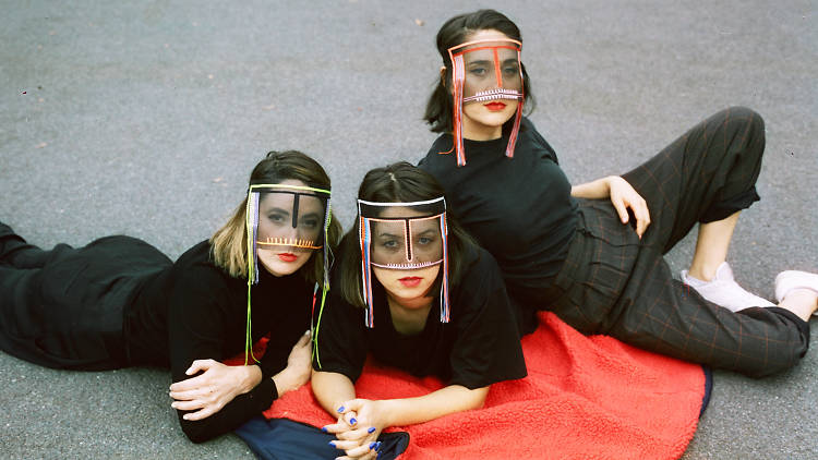 Haiku Hands Press shot for 2019 tour, band laying on the ground, masks on looking at the camera