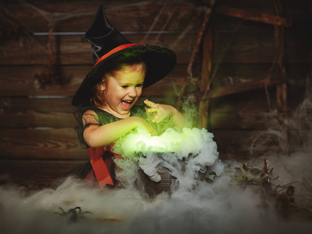 PantBank Halloween Child plays with fake cauldron.