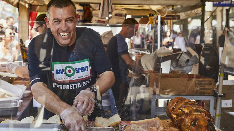 Man cuts up cured meat.