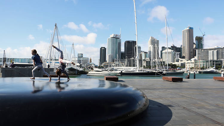 Children jumping on 'Moon Drops' art installation