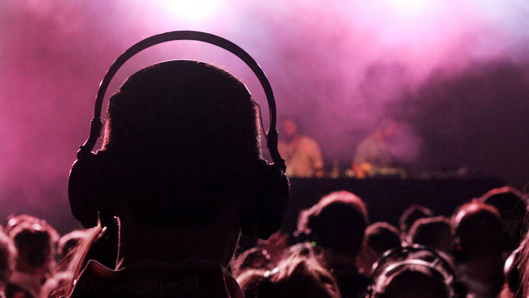 Person with headphones at a nightclub