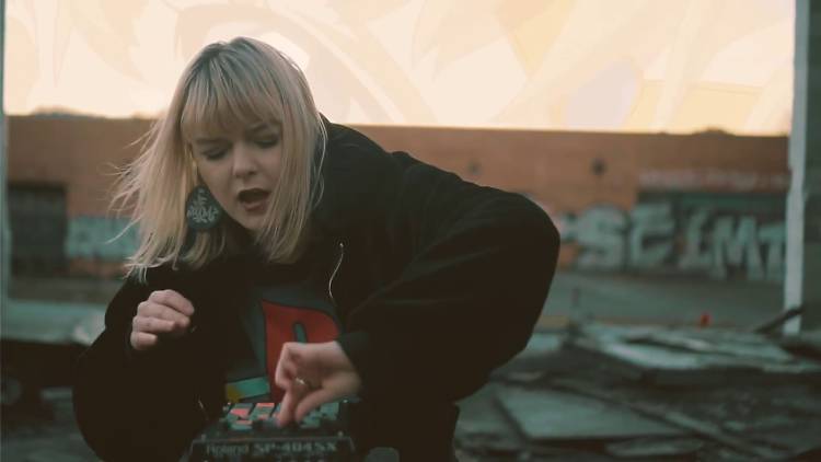 Woman uses DJ booth.