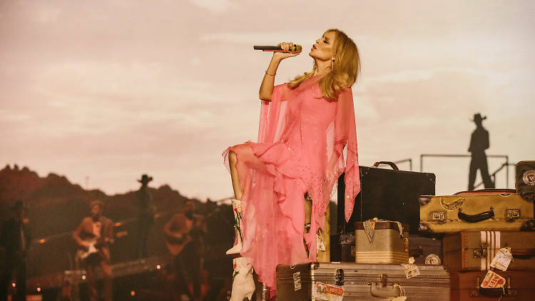 Kylie Minogue singing into microphone