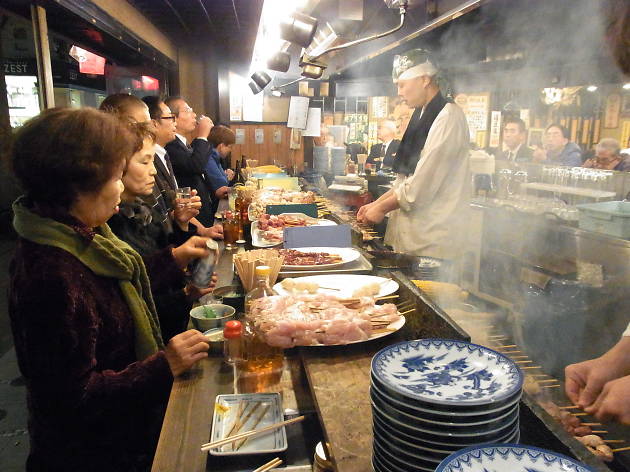 Mingle with salarymen at a small Yakitori stall under the train station in Shimbashi Mingle with salarymen at a small Yakitori stall under the train station in Shimbashi