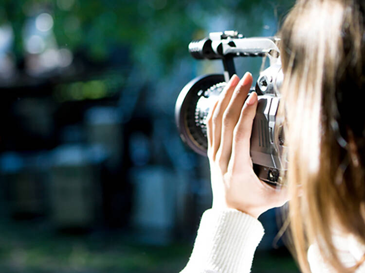 Woman shooting a video camera.