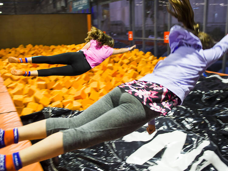 Kids jumping into the foam pit at Sky Zone.