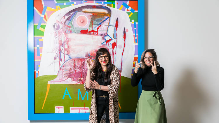 (L-R) Angie Goto using the sign for 'Auslan' and Sue Wright signing 'visual'