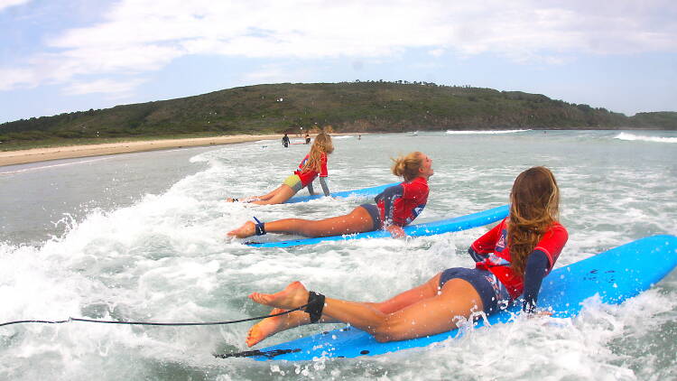 A group of people on a surfing lesson